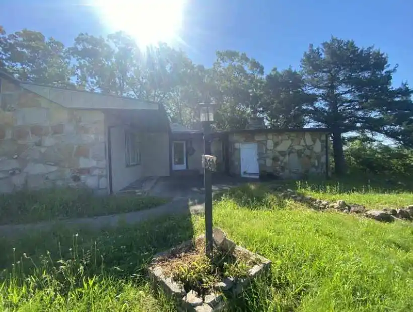 river frontage,  11 acres, timber, stone cottage